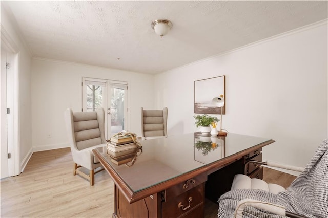 home office with french doors, ornamental molding, a textured ceiling, and light wood-type flooring