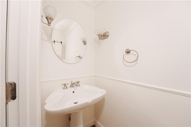 bathroom featuring crown molding and sink