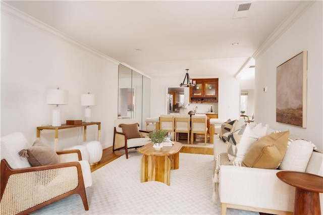 living room featuring crown molding and light wood-type flooring