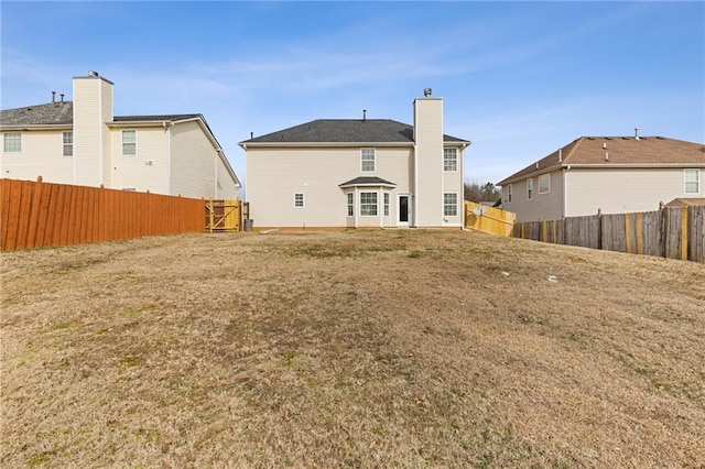 rear view of property with a yard