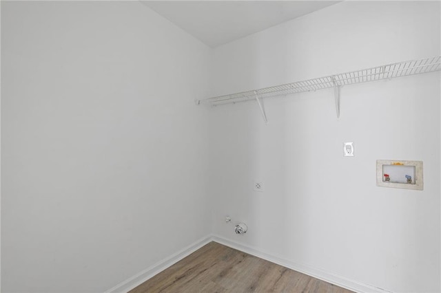 laundry area with hookup for a gas dryer, hookup for a washing machine, wood-type flooring, and hookup for an electric dryer