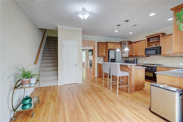 1160 Newpark View Pl Unit 8, Mableton, GA 30126 - kitchen featuring black appliances, open shelves, a kitchen bar, hanging light fixtures, and light wood finished floors