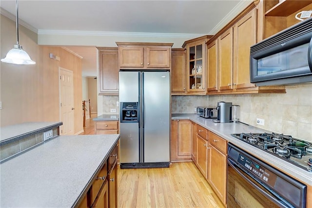 1160 Newpark View Pl Unit 8, Mableton, GA 30126 - kitchen featuring black appliances, brown cabinetry, pendant lighting, light countertops, and light wood-style floors
