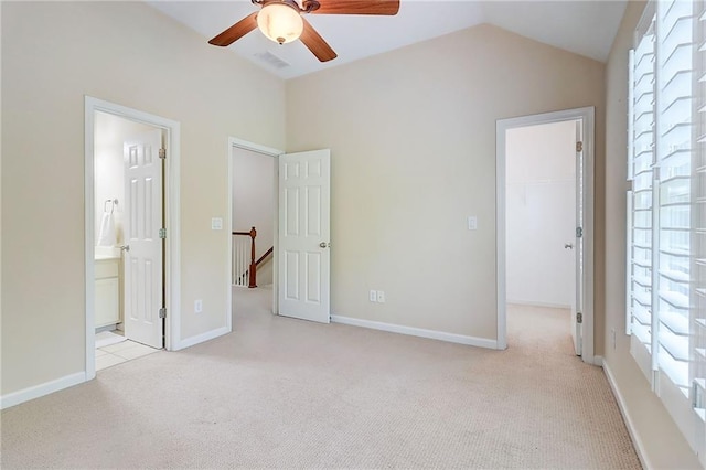 1160 Newpark View Pl Unit 8, Mableton, GA 30126 - unfurnished bedroom with a walk in closet, light carpet, multiple windows, lofted ceiling, and a closet