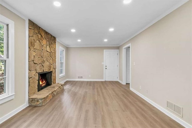1420 Fieldgreen Overlook, Stone Mountain, GA 30088 - unfurnished living room featuring light wood-type flooring, healthy amount of natural light, crown molding, recessed lighting, and a fireplace