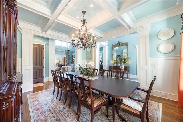 dining space with beamed ceiling, dark wood-type flooring, and decorative columns