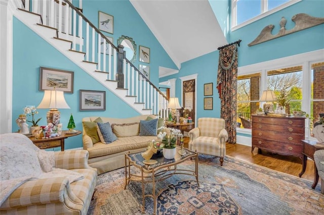 living room with hardwood / wood-style flooring, high vaulted ceiling, and a wealth of natural light