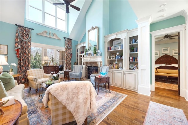 living room with a healthy amount of sunlight, ceiling fan, a fireplace, and light wood finished floors