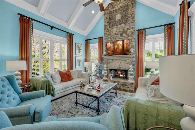 living room featuring a stone fireplace, ceiling fan, and lofted ceiling with beams