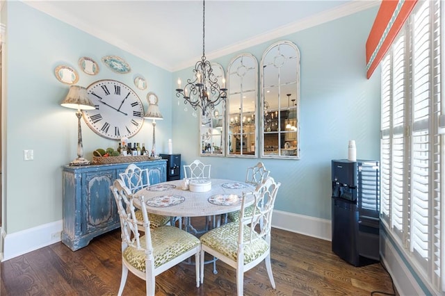 dining room featuring a notable chandelier, baseboards, and wood finished floors