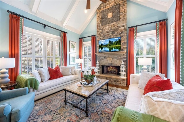 living area featuring beamed ceiling, high vaulted ceiling, and a fireplace