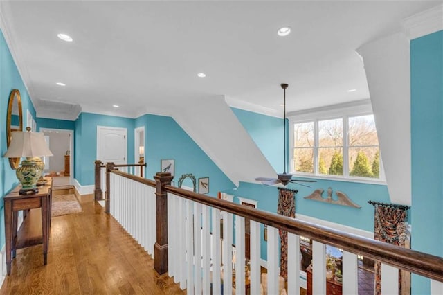 hall with hardwood / wood-style flooring and ornamental molding