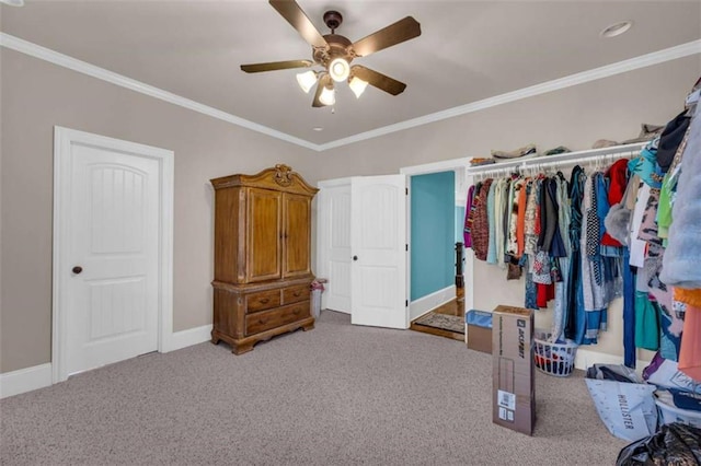 carpeted bedroom with ceiling fan, a closet, and crown molding