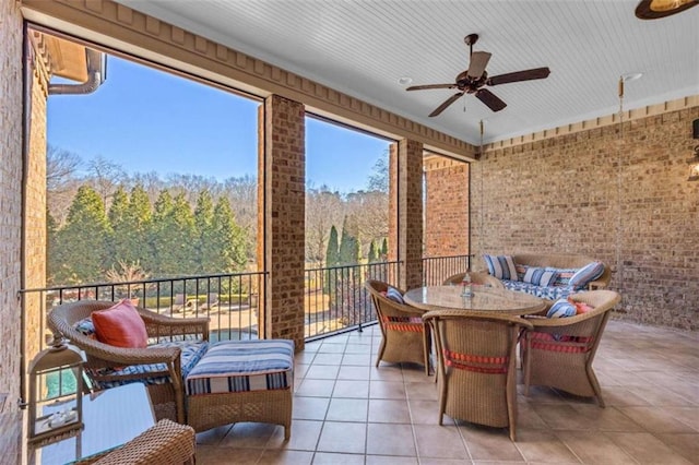 sunroom / solarium featuring ceiling fan