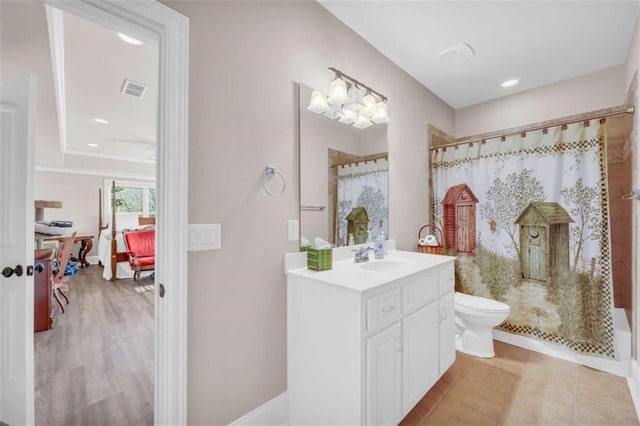 bathroom with a shower with curtain, vanity, toilet, and tile patterned flooring