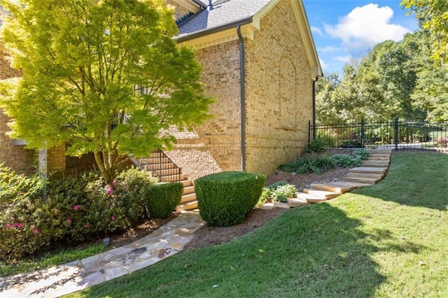 view of yard with stairway and fence