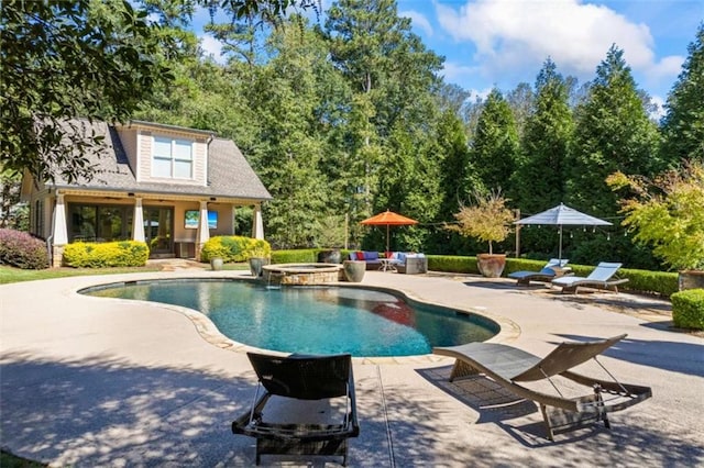 view of pool with a patio area and an in ground hot tub