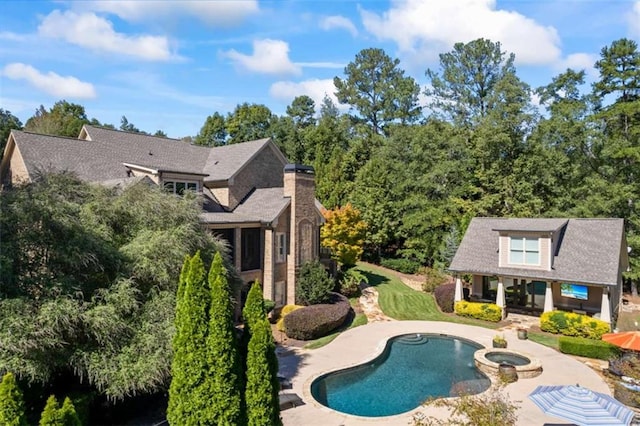 view of swimming pool featuring a patio area and an in ground hot tub