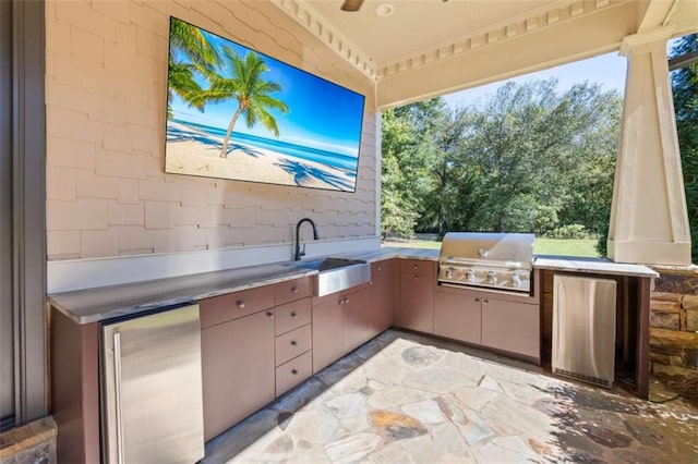 view of patio / terrace with ceiling fan, area for grilling, sink, and grilling area