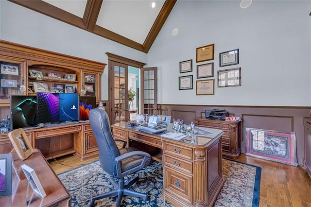 office space featuring beam ceiling, french doors, high vaulted ceiling, and hardwood / wood-style floors