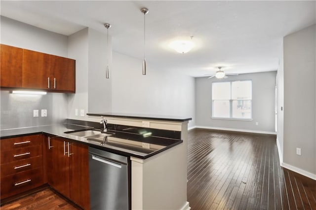 kitchen featuring kitchen peninsula, stainless steel dishwasher, dark hardwood / wood-style floors, ceiling fan, and sink