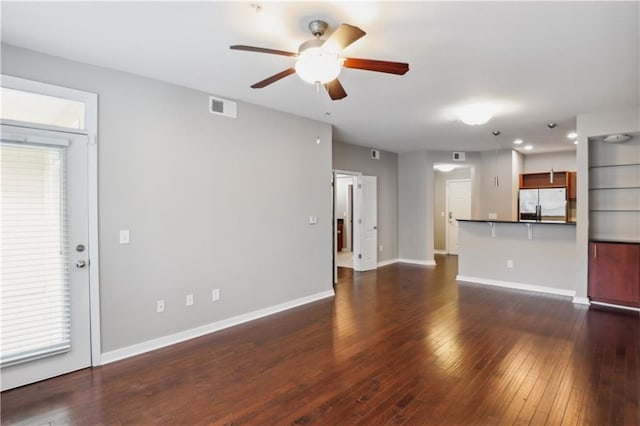 unfurnished living room with ceiling fan and dark hardwood / wood-style flooring