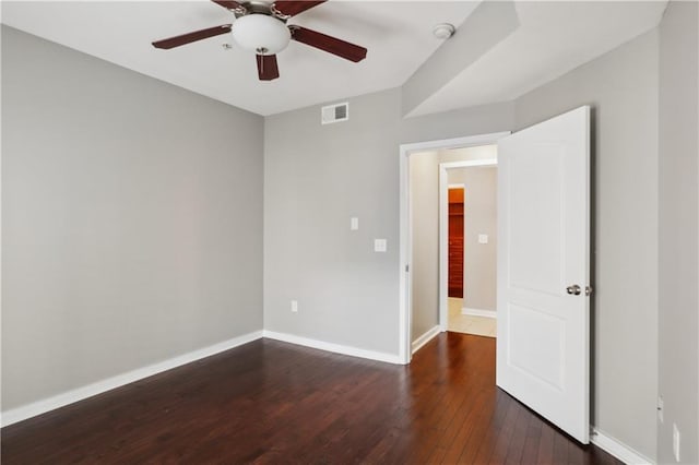 unfurnished room with ceiling fan and dark hardwood / wood-style flooring