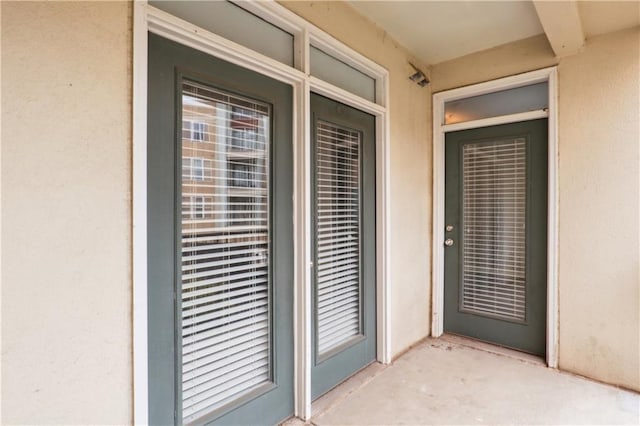 doorway to property with a patio