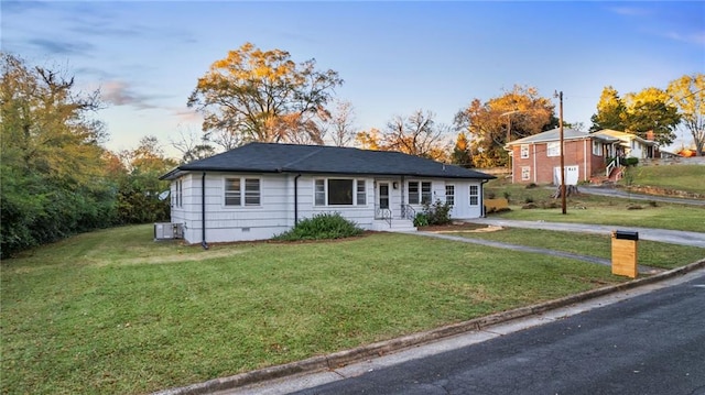 single story home with a yard and central AC