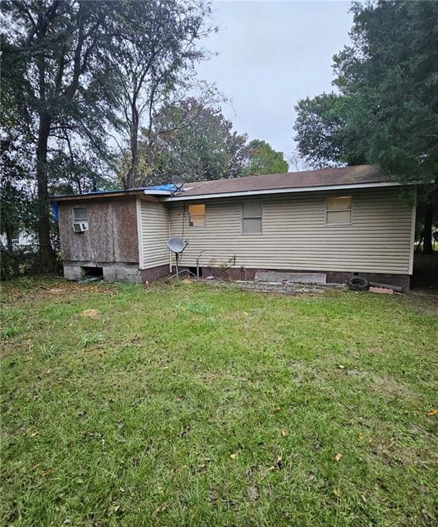 rear view of house with a lawn