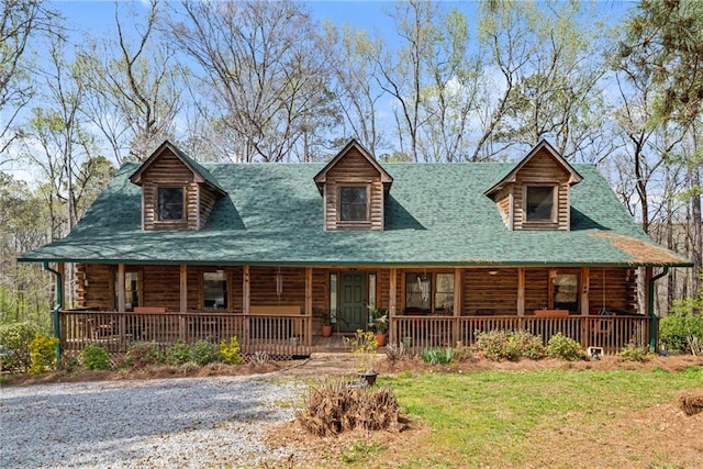 log cabin featuring a front lawn and a porch