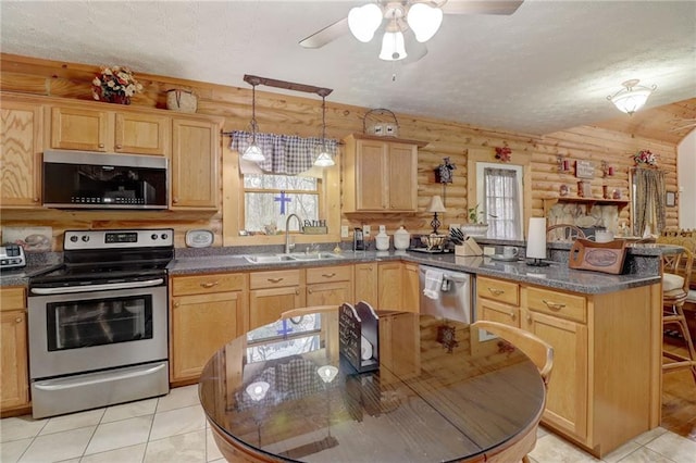 kitchen with sink, hanging light fixtures, stainless steel appliances, a textured ceiling, and light brown cabinets