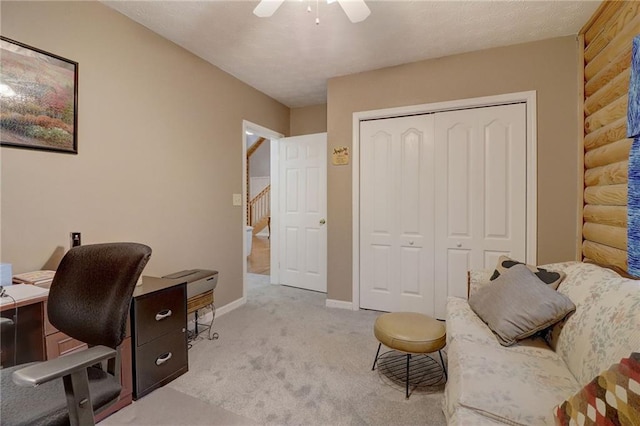 office space featuring ceiling fan and light carpet