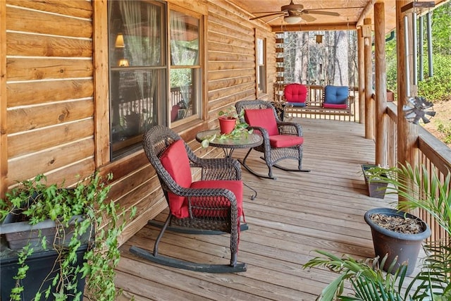 wooden terrace with ceiling fan and a porch