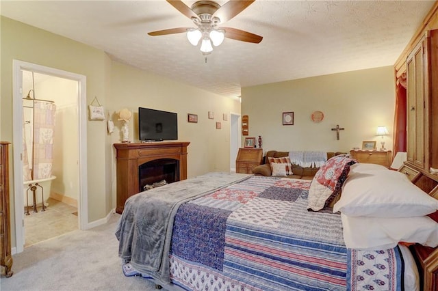 bedroom with ceiling fan, light carpet, and a textured ceiling