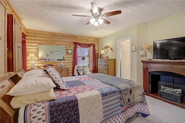 bedroom featuring ceiling fan, log walls, and a textured ceiling