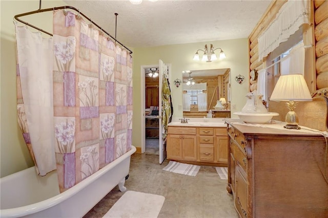 bathroom featuring a notable chandelier, vanity, shower / bath combination with curtain, and a textured ceiling