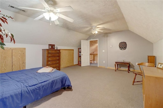 bedroom featuring lofted ceiling, ceiling fan, light colored carpet, and a textured ceiling