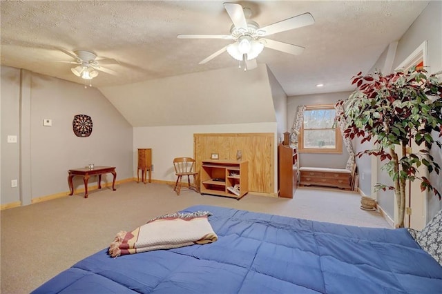 bedroom with ceiling fan, light colored carpet, lofted ceiling, and a textured ceiling