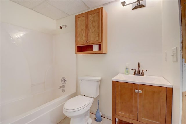 full bathroom featuring shower / tub combination, vanity, toilet, and a drop ceiling