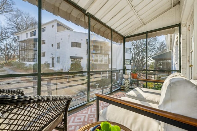 sunroom featuring lofted ceiling