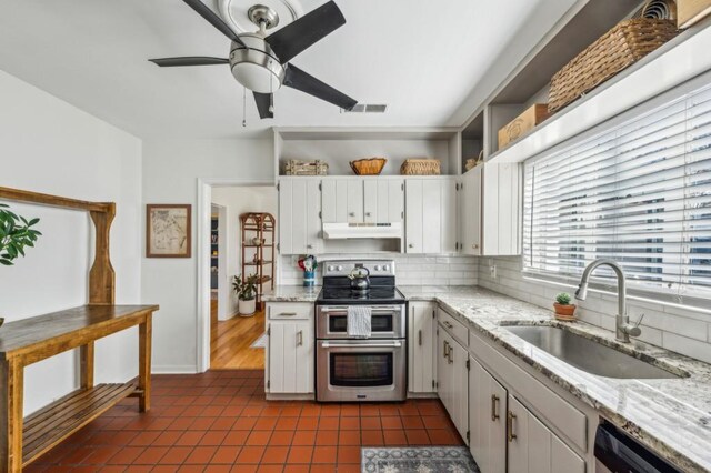 kitchen featuring under cabinet range hood, a sink, visible vents, white cabinets, and double oven range