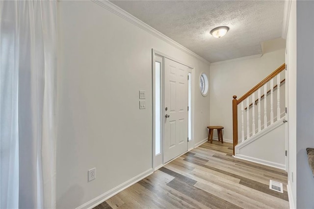 5407 Palmetto Ct, Flowery Branch, GA 30542 - foyer entrance with wood finished floors, stairs, a textured ceiling, baseboards, and crown molding