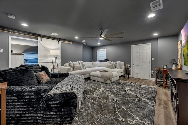 5407 Palmetto Ct, Flowery Branch, GA 30542 - living area with a barn door, ceiling fan, wood finished floors, and recessed lighting