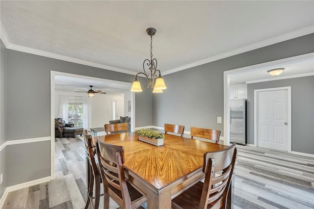 5407 Palmetto Ct, Flowery Branch, GA 30542 - dining area featuring light wood-style floors, crown molding, baseboards, a chandelier, and ceiling fan
