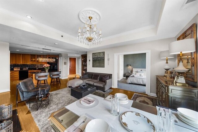 2881 Peachtree Rd NE Unit 1102, Atlanta, GA 30305 - living area featuring a chandelier, wood finished floors, a raised ceiling, recessed lighting, and baseboards
