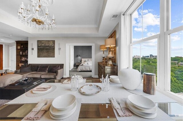 2881 Peachtree Rd NE Unit 1102, Atlanta, GA 30305 - dining space with a chandelier, a raised ceiling, crown molding, and baseboards