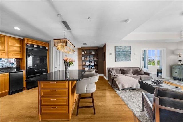 2881 Peachtree Rd NE Unit 1102, Atlanta, GA 30305 - living area with a chandelier, light wood finished floors, recessed lighting, and baseboards