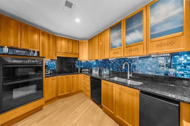 2881 Peachtree Rd NE Unit 1102, Atlanta, GA 30305 - kitchen featuring black appliances, a sink, light wood-style floors, and dark stone countertops