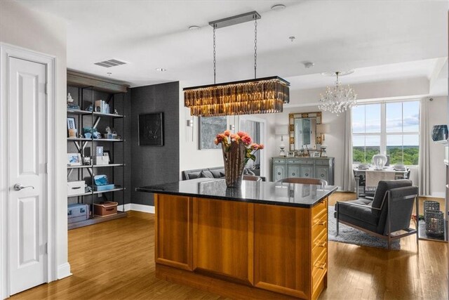 2881 Peachtree Rd NE Unit 1102, Atlanta, GA 30305 - kitchen with dark wood finished floors, open floor plan, a chandelier, and a kitchen island